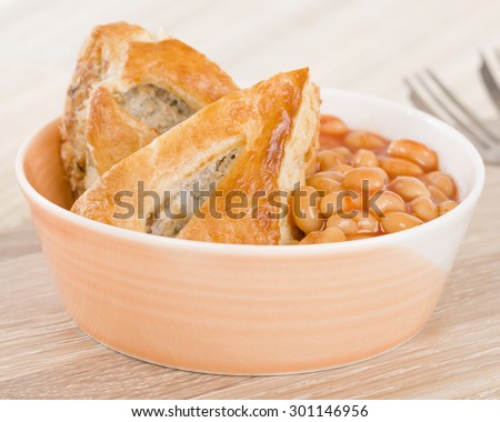 Sausage Roll & Beans - Bowl of sausage roll and baked beans.