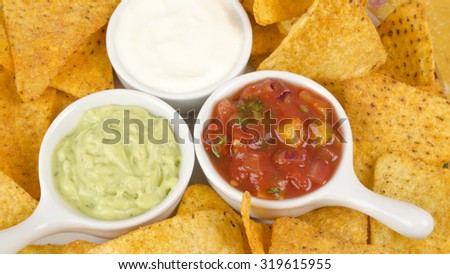Nachos - Tortilla chips served with guacamole, sour cream and salsa dips.