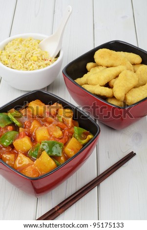 Sweet and Sour Chicken - Chinese fried chicken, sweet and sour sauce with bell peppers and pineapple with a side dish of egg fried rice.