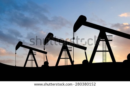 silhouette view of Oil pumps and sunset. Oil industry equipment.
