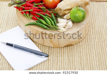 Food ingredients for cooking with note book and pen.