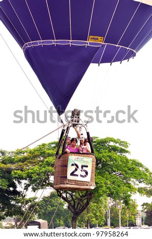 PUTRAJAYA, MALAYSIA-MAR 17: Hot air balloon bring up visitors flight on sky at the 4th Putrajaya International Hot Air Balloon Fiesta Mar 17, 2012 Putrajaya.