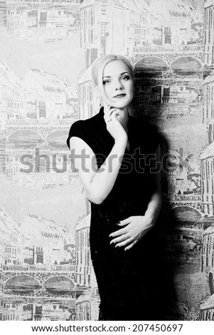 Blonde in black dress in interior black and white photography