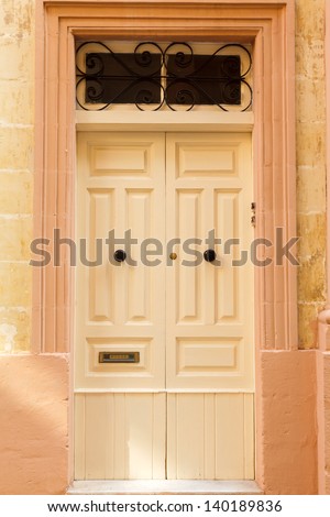 Light  wooden front door to the house in the Mediterranean