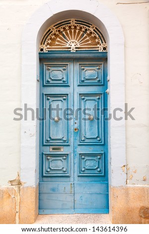 blue wooden front door to the house in the Mediterranean
