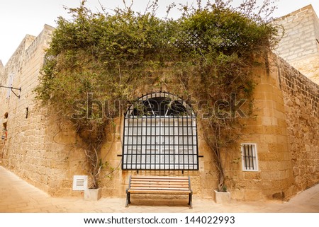 window to the old wall and bench underneath. Mdina, Malta, 2013
