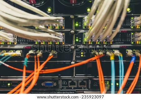 rack in the data center with working equipment with optical and UTP cables