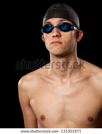 Young adult male swimmer. Studio shot over black.