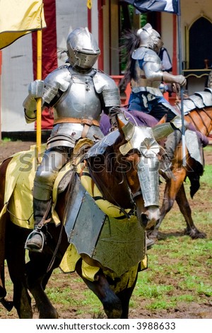 Mounted knight in a jousting show at a renaissance fair.
