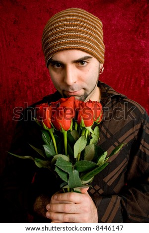 A young man with a dozen red roses.