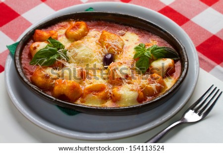 Delicious italian style casserole pasta dish with rich tomato sauce and plenty of shredded and melted mozzarella cheese. Restaurant set up with fork