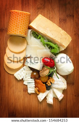 Variety of dairy products. Choice of cheese on wooden board. Overhead shot