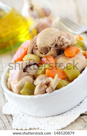Rabbit stew cooked with carrots and celery served in a white oval plate