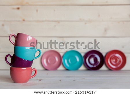 Bright dishes on table on a wooden background
