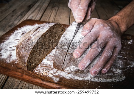 food. man\'s hands cut bread, homemade