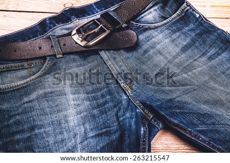 Detail of nice blue jeans with leather belt