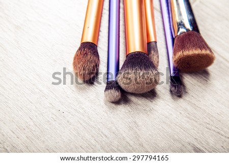 collection of make-up brushes over white