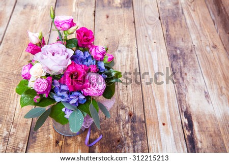 flowers. bouquet of roses in a bucket on a white wooden background