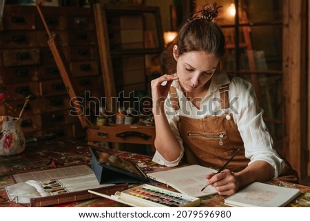 Similar – Image, Stock Photo Female artist drawing with pencil in art studio