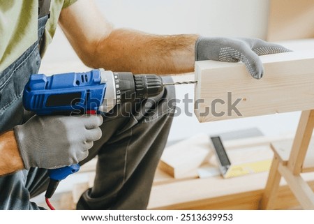 Similar – Image, Stock Photo Unrecognizable handyman using machine on factory