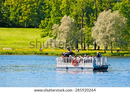 TSARSKOYE SELO, SAINT-PETERSBURG, RUSSIA - JUNE 7, 2015: People on the ferry on the Great Pond. The historical Ferry line connects the Catherine Park near Admiralty with the Hall on the Island