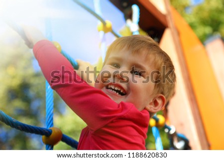 Similar – Image, Stock Photo Little caucasian boy enjoying sun and wind travelling in a car with open window.