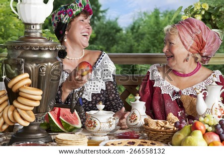 Mature women from the Victorian era carefree laugh while having a cup of tea. Kustodiev Russian artist style