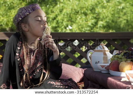 Pretty Oriental girl  has breakfast with fruits and flat cake