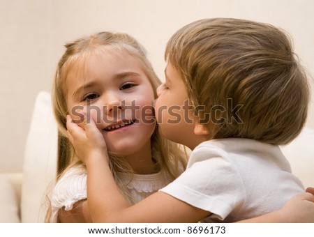 Little boy kiss his sister
