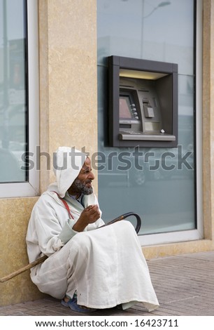 AGADIR - JUNE 12: Beggar sitting near cash machine June 12, 2008 in Agadir, Morocco