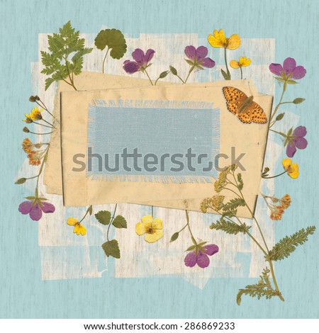 Background for an inscription with dried wild flowers, fabrics and old paper.