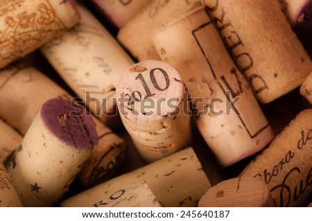 Several Wine Corks on a white background. You can read the Origin of the Wine and or the Vintage on them.