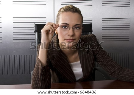 Young attractive blond business woman in a modern office setting