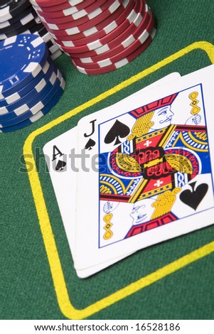 Game of blackjack at a casino with chips on a green blackjack table