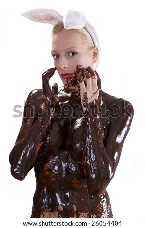 Attractive naked blond girl covered in chocolate wearing bunny ears