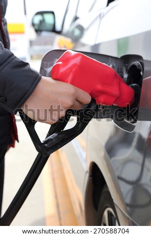 background of hand filling the car fuel of the car