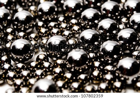 Metallic bearing balls on white background