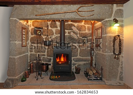 old fireplace made of stone and iron stove