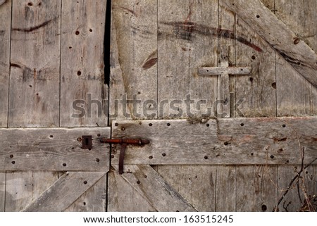 old door made of wood with a carved cross