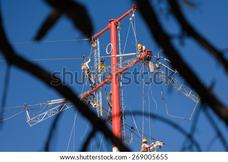 Workers repairing a high voltage industrial power energy line. Great for energy, safety and technology themes. : Almada, Portugal - October 02, 2008
