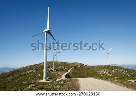 Wind Turbines on a modern windmill farm for alternative energy production. Electricity is powered ecological and considered better for the environment over oil and other fossil fuels.