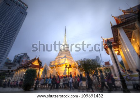 BANGKOK - JULY 29 : Thai Buddhists gather together to hold the holy ceremony by walking with lighted candles in hand around a temple to celebrate ASALAHA BUCHA on 29 July 2012 at Phatumwanaram temple.