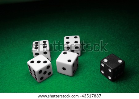 Dice separated over a table of green felt