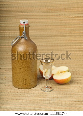 vodka bottle with apple on the wood table table