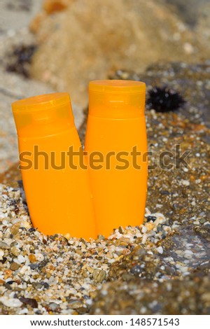 suntan lotion bottle in the sand