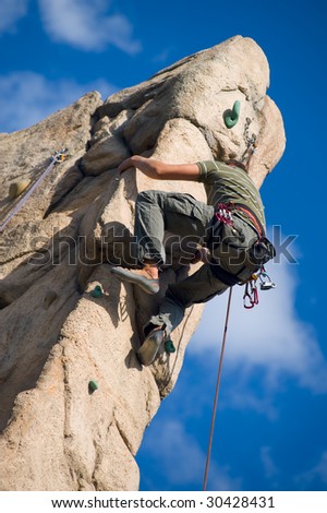 Climber climbing up the wall