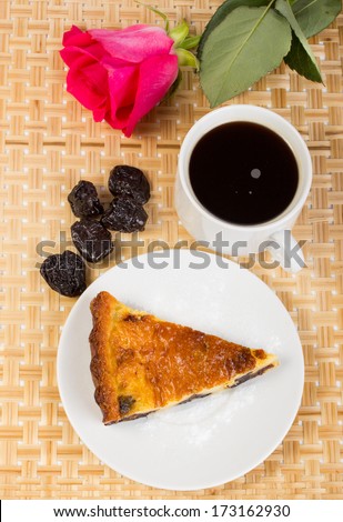 Romantic dinner from prunes and coffee pie against a pink rose