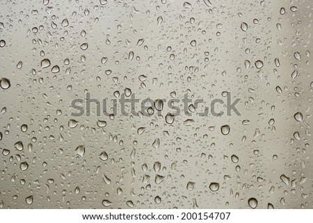 Texture from rain drops at a window against the house