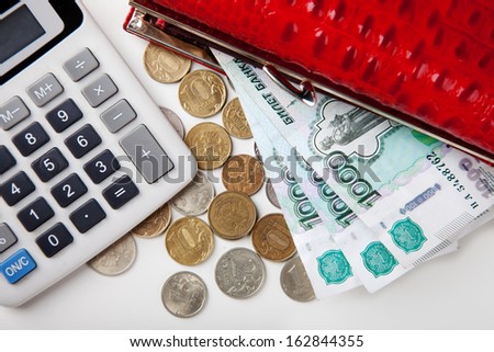 purse with paper money and coins, calculator on a white