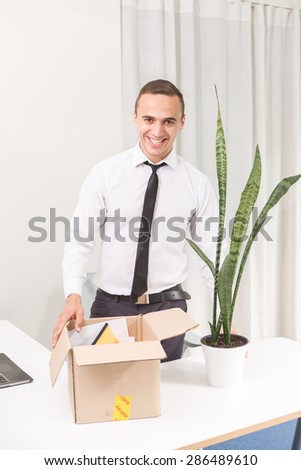 Happy just fired an office worker with box of personal stuff